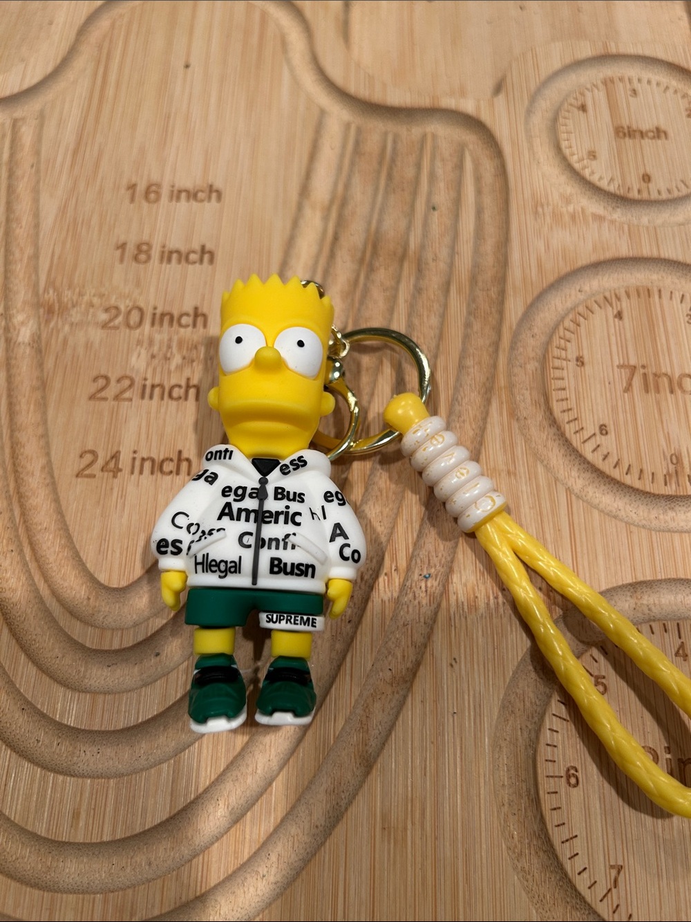 Supreme Yellow Bart Simpson Keychain with White Logo Jacket and Green Shorts